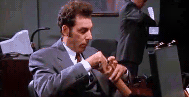Kramer eats crackers from his briefcase